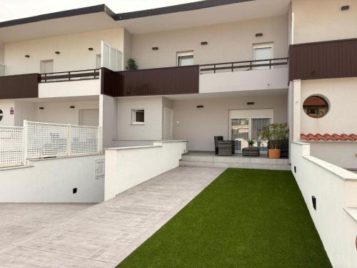 an exterior view of a house with a green lawn at Casa Manolo in Luanco