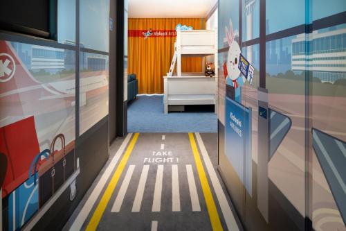 a hallway with a sign that says take flight at Crowne Plaza Changi Airport by IHG in Singapore