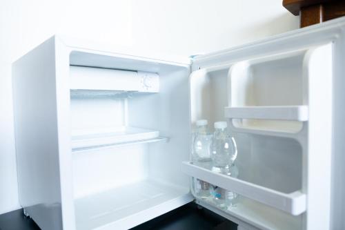 an open refrigerator with bottles and glasses in it at Bed & Breakfast Giardini Di Marzo in Lecce