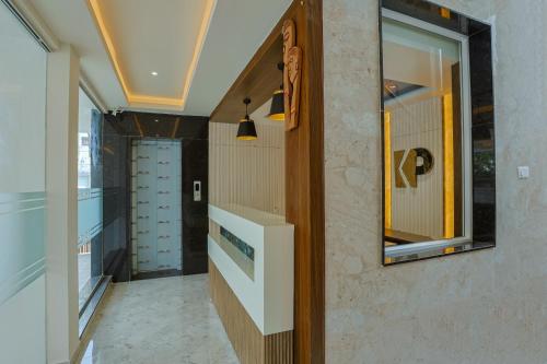 a hallway with a mirror on the wall at Kayal Plaza in Coimbatore
