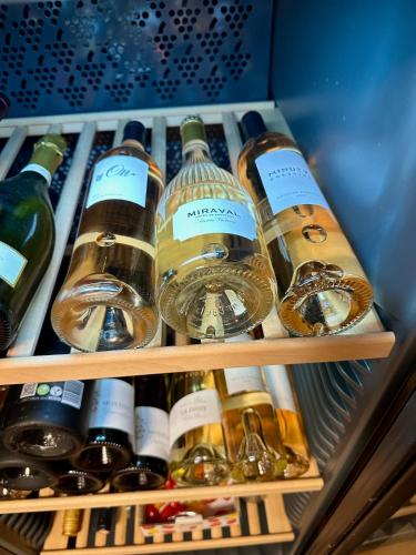 a refrigerator filled with lots of bottles of wine at Le Clos du Vialle in Grillon