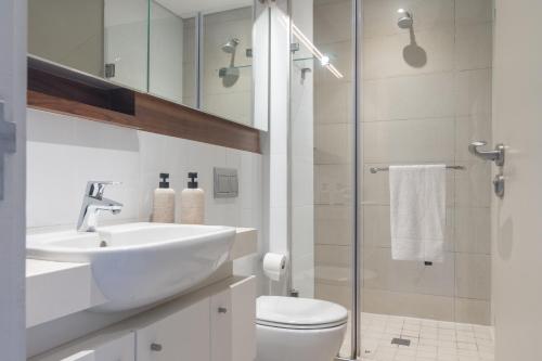 a bathroom with a sink and a toilet and a shower at Zimbali Suites 617 in Ballito