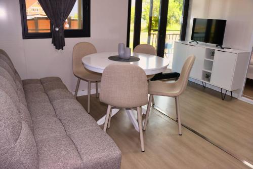 a living room with a couch and a table with chairs at Rama holiday resort in Prozor