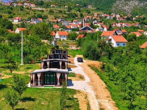 a house on a dirt road in a village at Rama holiday resort in Prozor