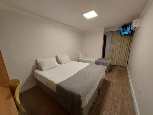 a bedroom with a bed and a television in it at Alfa Plaza Hotel in Brasilia