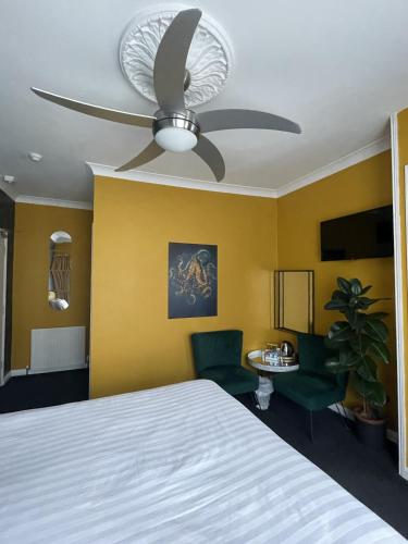 a bedroom with a bed and a ceiling fan at The Montana in Torquay