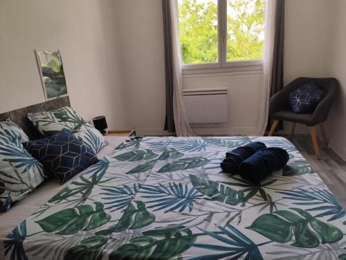 a bedroom with a bed and a chair and a window at villa skys France in Gien