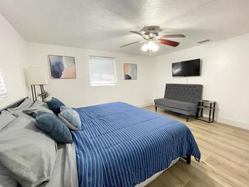 a bedroom with a bed and a ceiling fan at Pool Beach House in New Port Richey