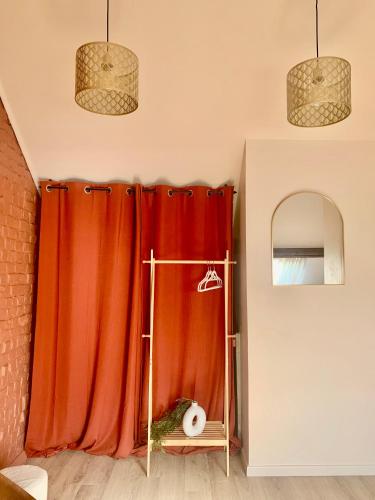 a room with a red curtain and a mirror at Chaleureuse et spacieuse chambre, sdb privative in Lille