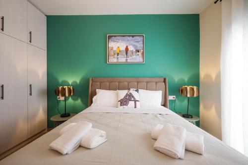 a bedroom with a large bed with green walls at Aegean Nest I Seaside 3 bedroom Apartment in Alexandroupolis in Alexandroupoli