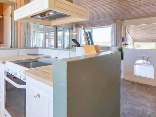 a kitchen with white cabinets and a counter top at 12 person holiday home in Hjørring in Lønstrup