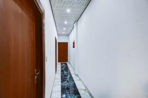 a hallway with a tile floor and a ceiling at Collection O Sikandra Near Akbar Tomb in Agra