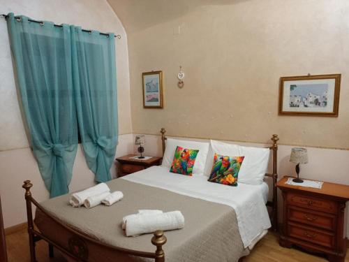 a bedroom with a bed with two towels on it at La loggia del pappagallo in Gallese