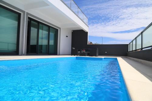 a swimming pool on the roof of a house at A&M House in Arco da Calheta