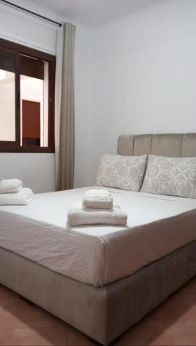a bedroom with a bed with towels on it at Coastal Apartment in Cabo in Cabo Negro