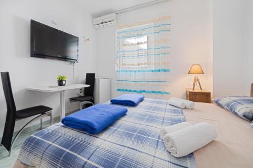 a bedroom with two blue pillows on a bed at Apartment Dragicevic 3 with Garage in Budva
