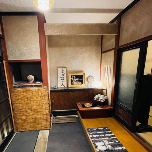 a room with a table and a shelf and a door at Mahiru no Tsuki - Vacation STAY 15230v in Akasaki