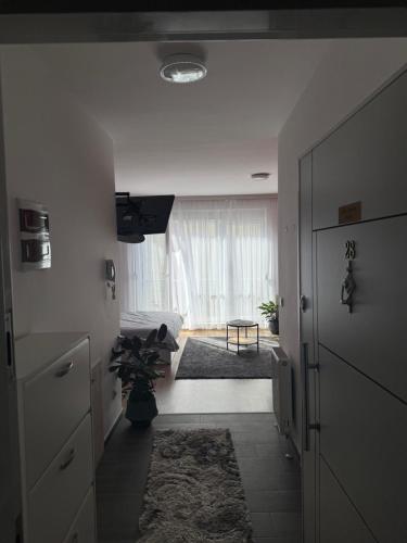 a hallway with a living room with a window at Apartament-in center of prishtina 3 in Pristina