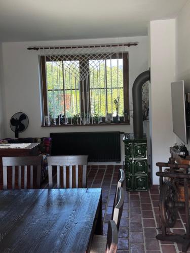 a living room with a wooden table and a stove at Cisna Chata - Bieszczady in Cisna