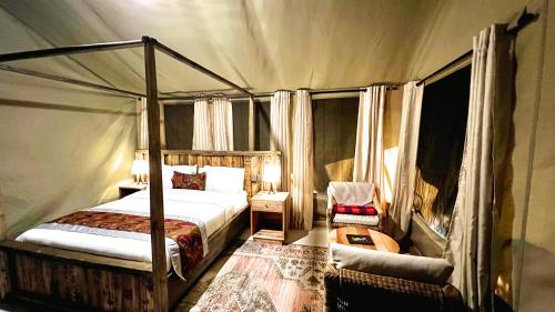 a bedroom with a canopy bed in a tent at Uyoga House in Arusha