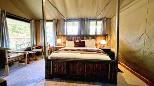 a bedroom with a bed in a tent at Uyoga House in Arusha