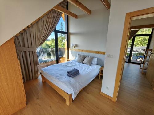 a bedroom with a bed with a bag on it at Matygowa Osada in Gliczarów Górny