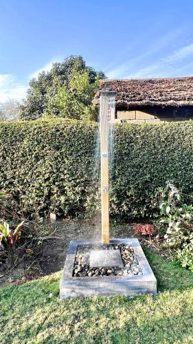 a water fountain in the middle of a yard at Uyoga House in Arusha