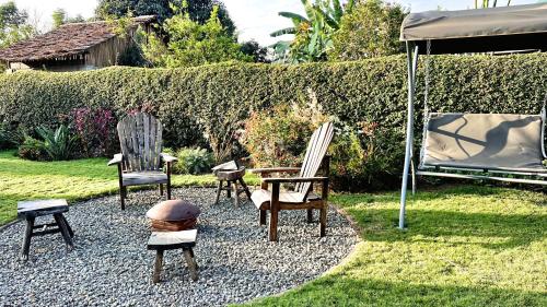 a group of chairs and an umbrella in a yard at Uyoga House in Arusha