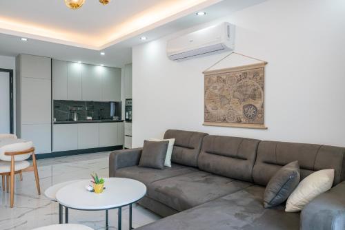 a living room with a couch and a table at Palmera Resort Wellness & SPA in Kérynia