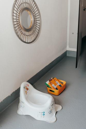 a white urinal sitting on the floor next to a mirror at DS Camping in Grgar
