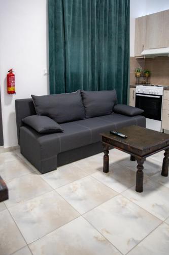 a living room with a couch and a coffee table at Zoufi Cozy Living in Patra