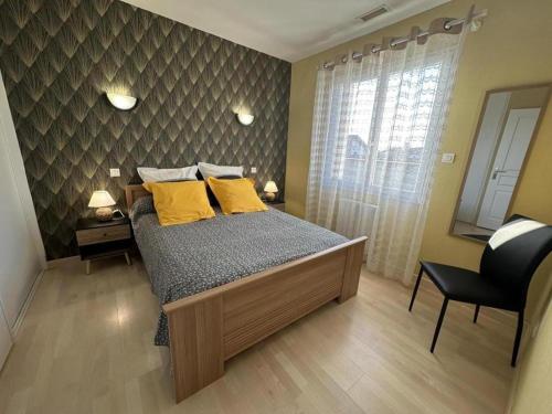 a bedroom with a bed with yellow pillows at Gite montanet in Mées