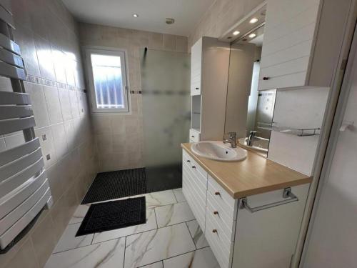 a white bathroom with a sink and a mirror at Gite montanet in Mées