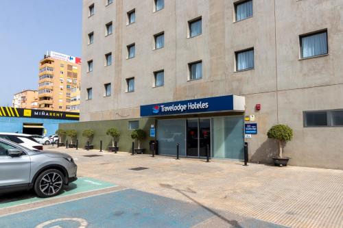 a car parked in front of a building at Travelodge Málaga Airport in Málaga