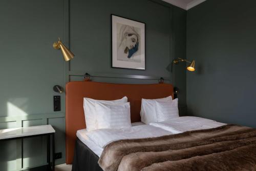 a bedroom with a large bed with white sheets at Scandic Grand Central Helsinki in Helsinki