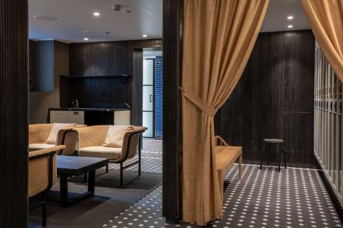 a living room with a couch and a table at Scandic Grand Central Helsinki in Helsinki
