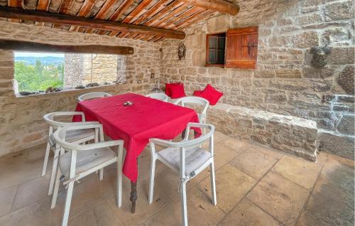 a dining room with a red table and chairs at Nice Home In Barjac With Wifi in Barjac