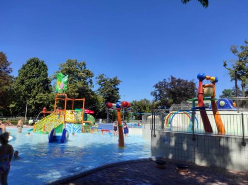 a water park with children playing in the water at Era Apartman in Harkány