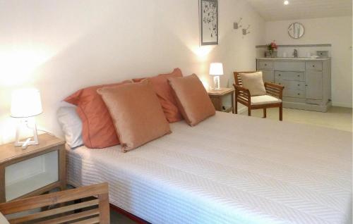 a bedroom with a large bed with orange pillows at Largeteau Astronomer's House in Saint-Maurice-le-Girard