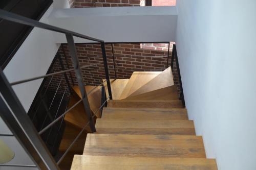 a staircase in a loft with a brick wall at Great Polonia The Granary La Suite Hotel in Wrocław
