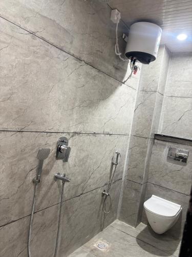 a bathroom with a shower and a toilet in it at Hotel shree Gajanand palace in Ujjain