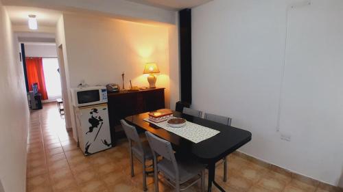 a kitchen with a dining room table and a refrigerator at Destino Sur in Esquel