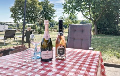 two bottles of wine on a table with a glass at 3 Bedroom Lovely Home In Beesel in Beesel