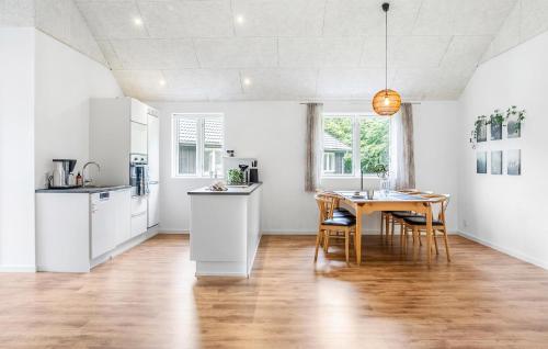 a kitchen and dining room with a table and chairs at 3 Bedroom Amazing Home In Toftlund in Toftlund