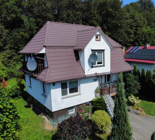 an aerial view of a house with a brown roof at Domek Żabie Oczko in Jarnołtówek