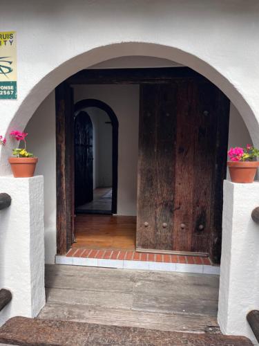 an entrance to a house with a wooden door at Vistas al Mar in Groot Brak Rivier
