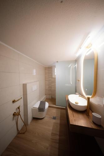 a bathroom with a white sink and a mirror at Aegean Nest I Seaside 3 bedroom Apartment in Alexandroupolis in Alexandroupoli
