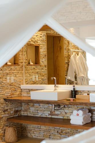 a bathroom with a sink and a mirror at Villa Praia - La Villa Group in Jericoacoara