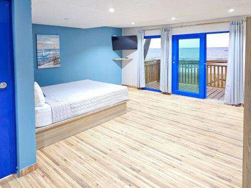 a bedroom with a bed and a view of the ocean at Brusea by the Beach in Camuy
