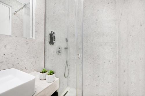 a bathroom with a shower and a sink at ICON Urban Living in Thessaloniki